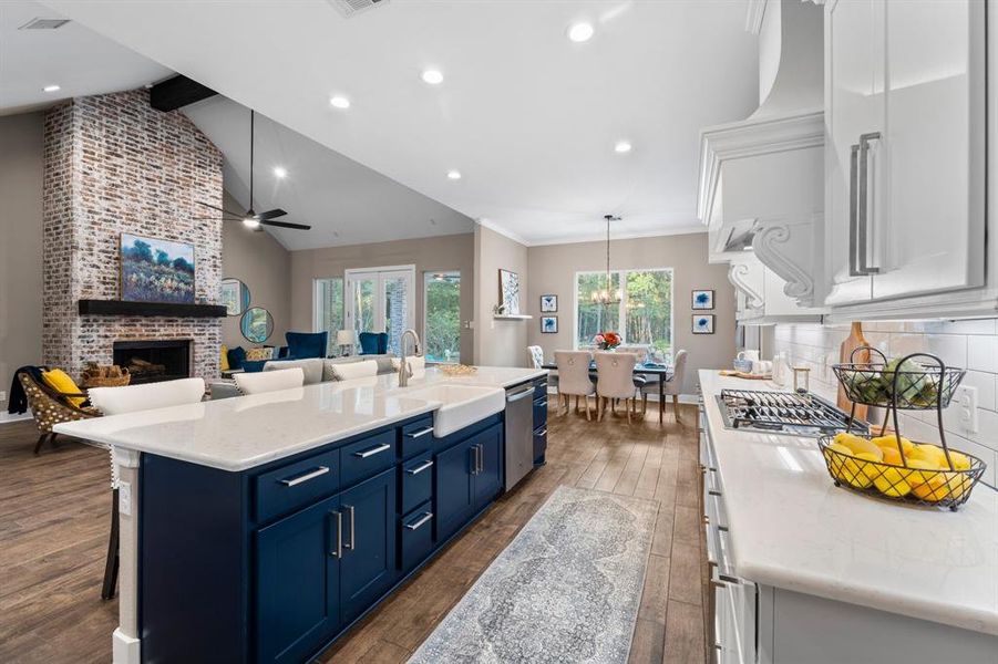 The island feature acts as an accent piece painted a rich blue color to give this kitchen a little "POP"! This kitchen is not just a place to cook; it's a gathering spot where memories are made and flavors come to life.