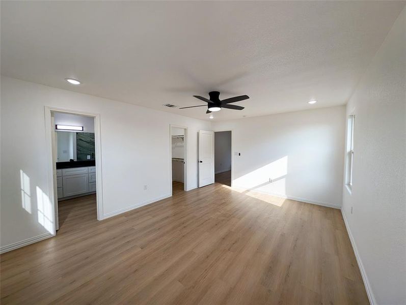 Empty room featuring ceiling fan and light hardwood / wood-style flooring