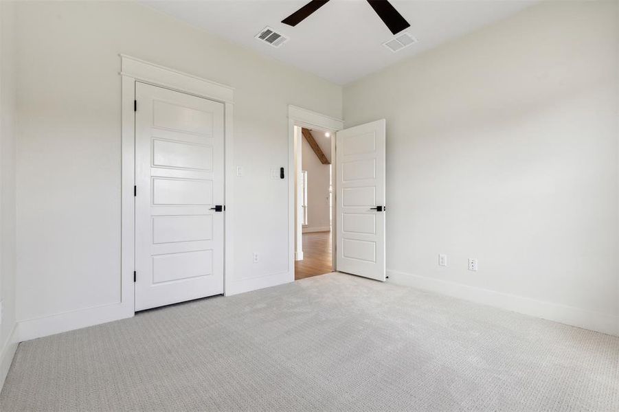 Unfurnished bedroom featuring ceiling fan and light carpet