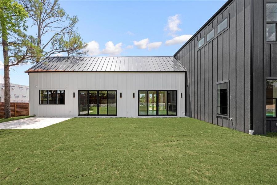 Rear view of property featuring a patio area and a yard