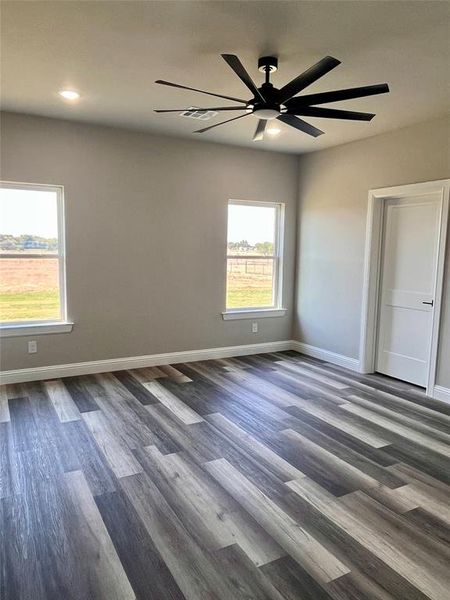 Spare room featuring dark hardwood / wood-style flooring and ceiling fan