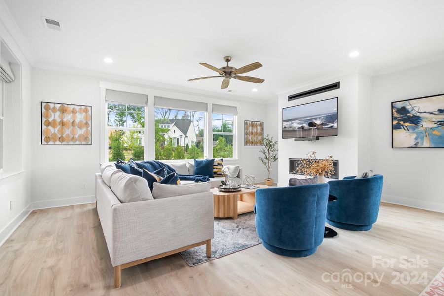 Great Room with wood floors and ceiling fan.