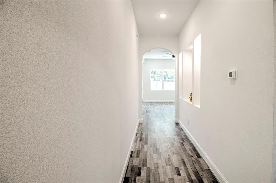 Corridor with hardwood / wood-style flooring
