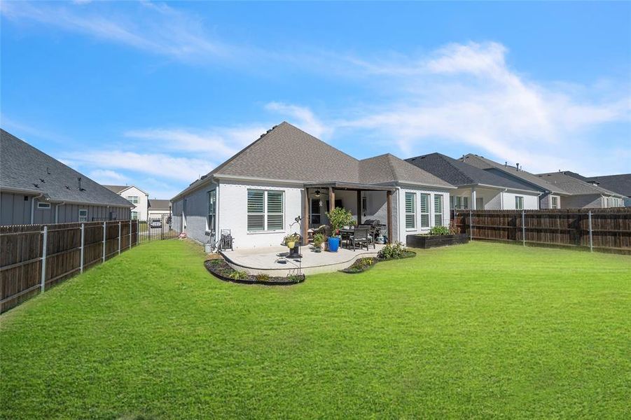 Back of house featuring a patio and a lawn