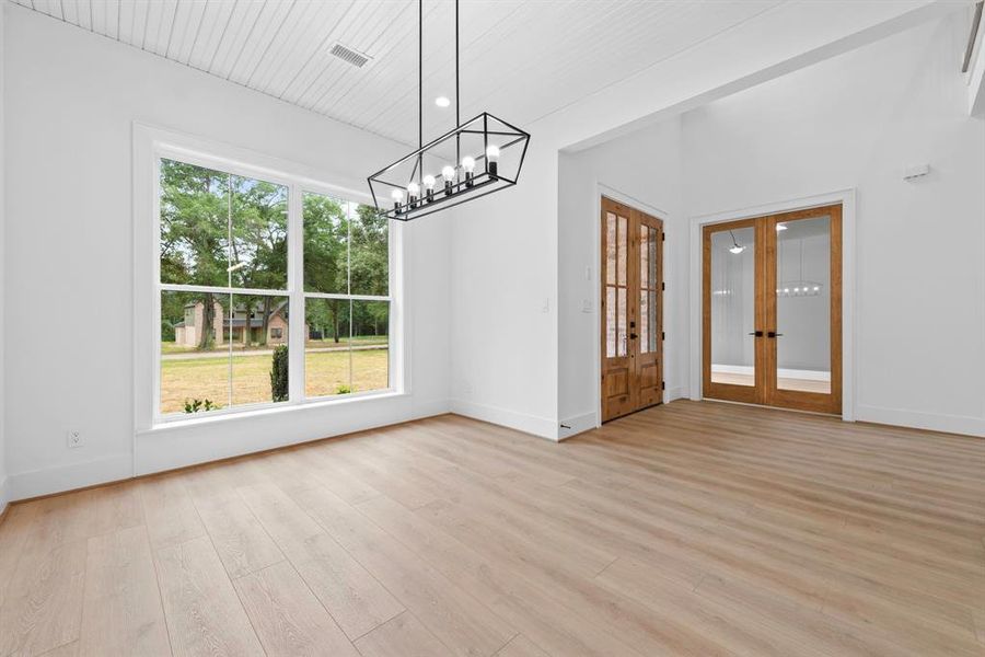 Dining room with bead board ceiling detail.