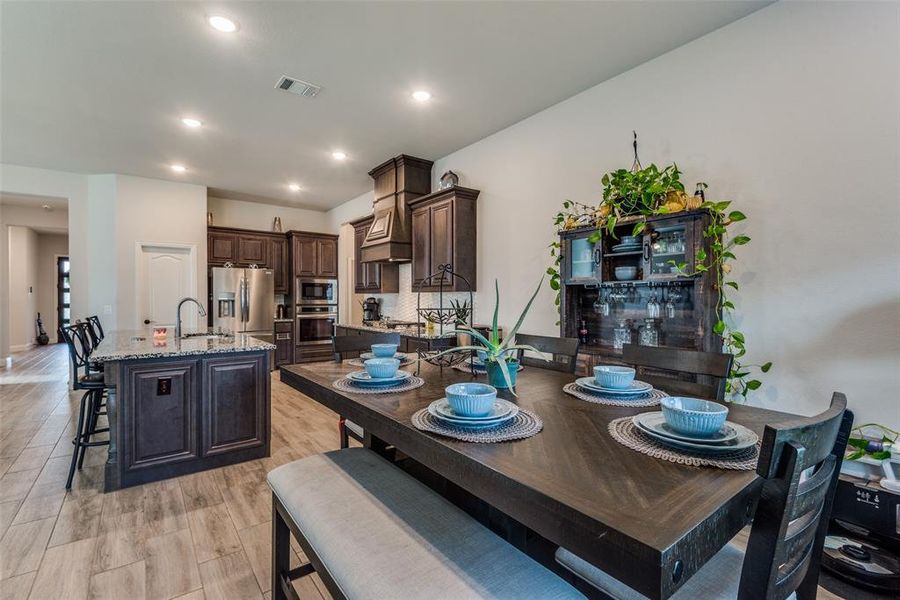 Dining space with sink and light hardwood / wood-style floors