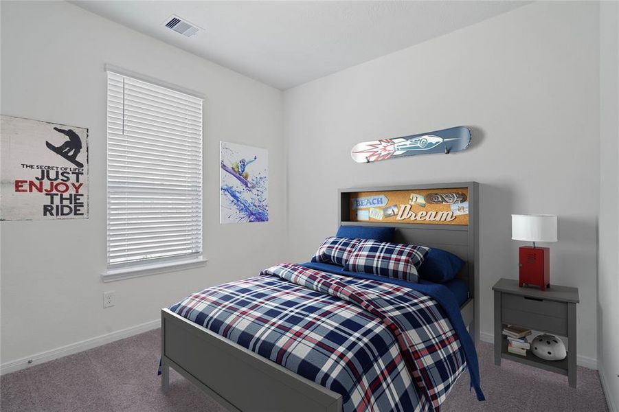 Secondary bedroom features plush carpet, neutral paint, lighting, large windows with privacy blinds and ample sized closet space.