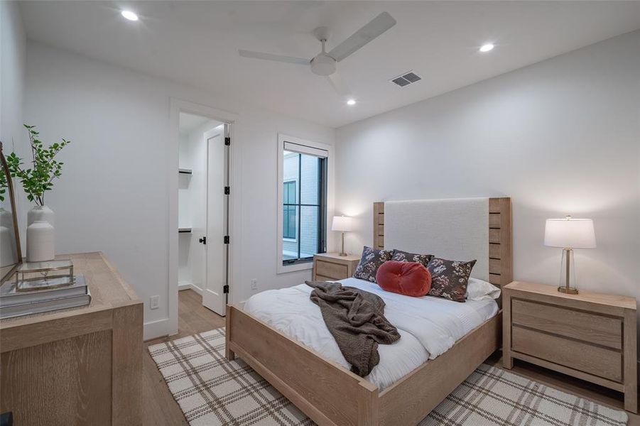 Bedroom with light hardwood / wood-style flooring and ceiling fan