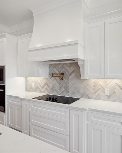 Kitchen with custom exhaust hood, stainless steel appliances, crown molding, white cabinets, and backsplash