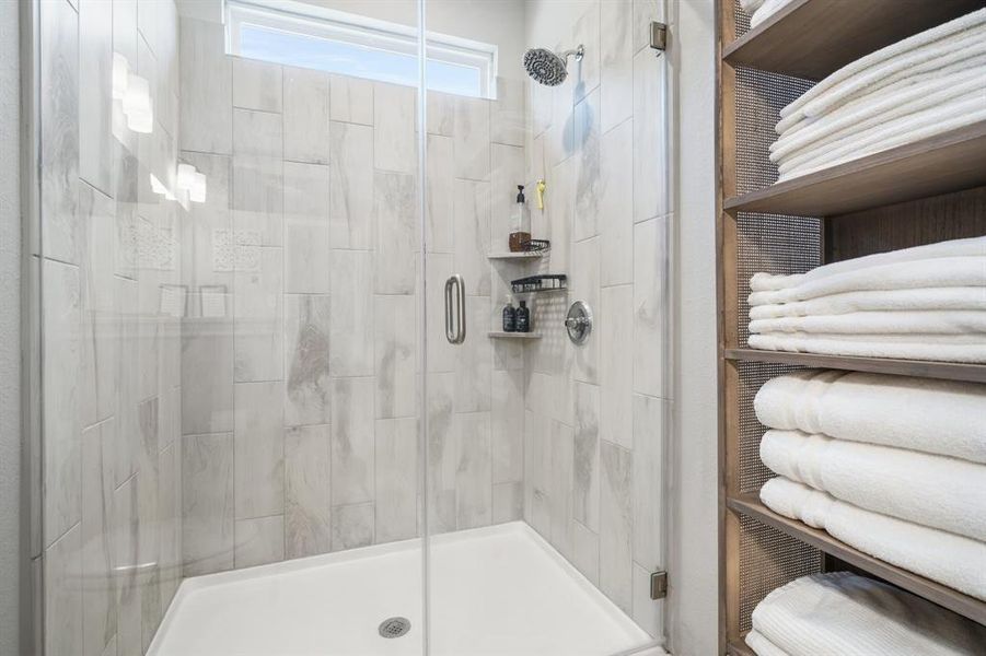 Tile surround walk-in shower with corner shelf to hold your shampoos and soaps, etc.