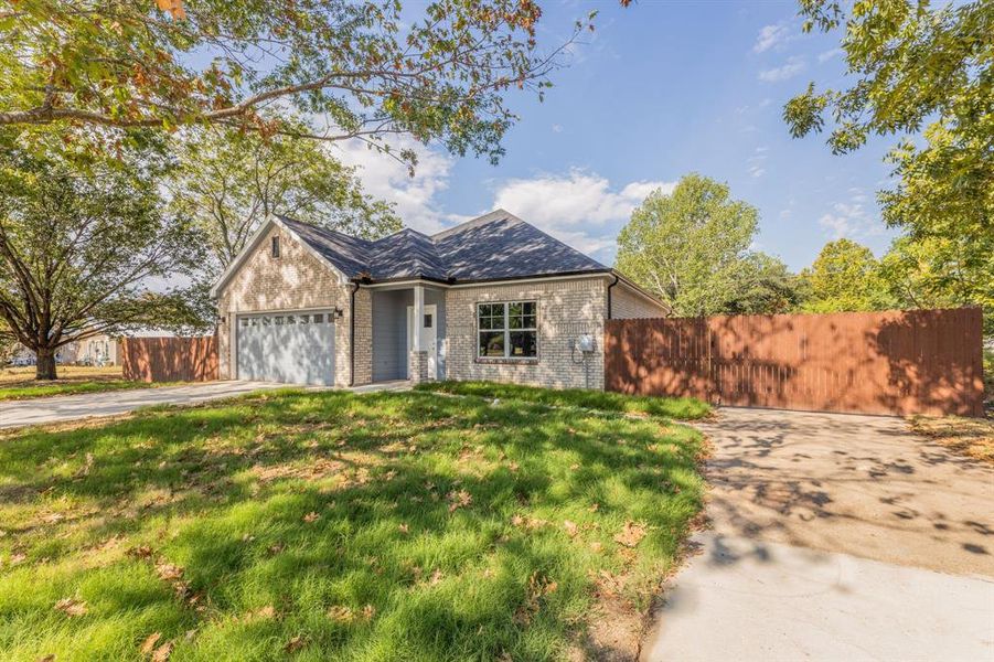 View of front of home featuring a garage and a front lawn