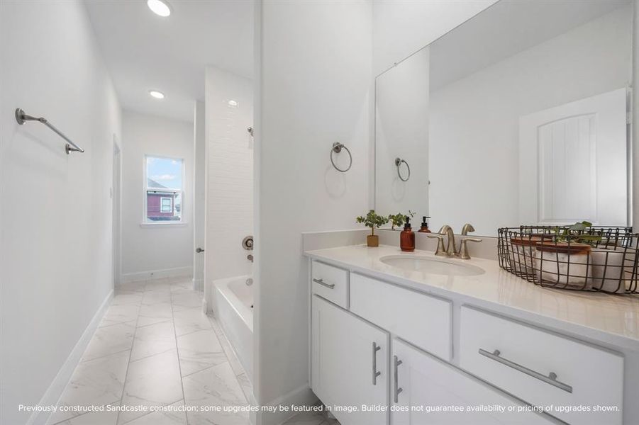 This secondary bathroom features a convenient Jack and Jill configuration, offering seamless access from both adjoining bedrooms for shared, yet private, use.