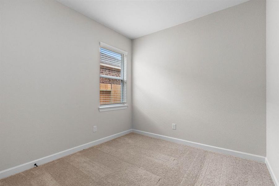 One of the two additional bedrooms in the home.