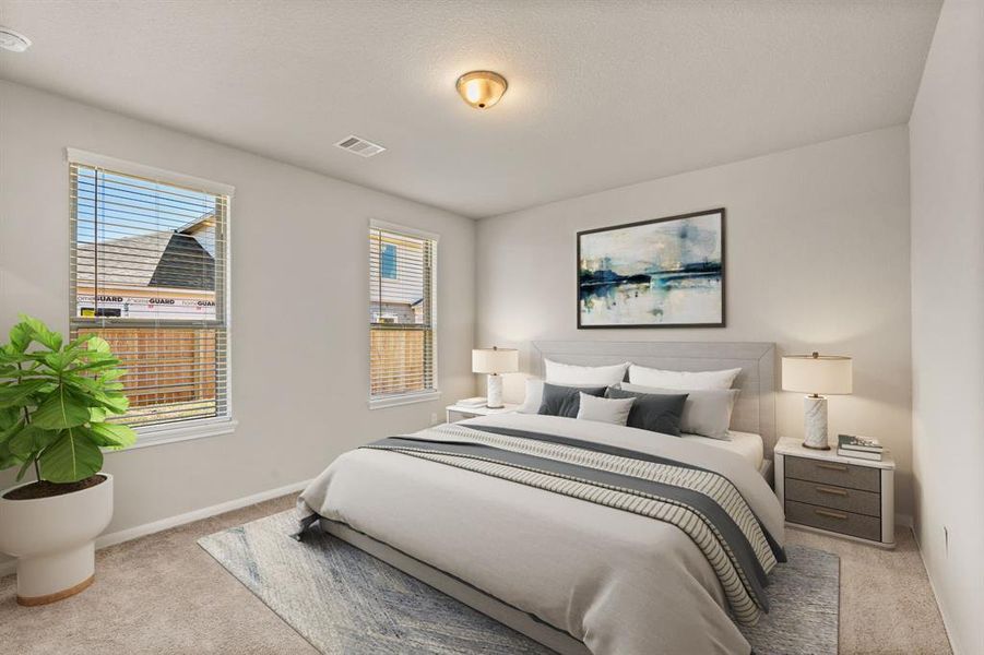 The primary bedroom is generously sized, creating a tranquil and spacious retreat that offers ample room for relaxation. Featuring plush carpet, high ceilings, fresh paint, and large windows that lets in natural lighting throughout the day.