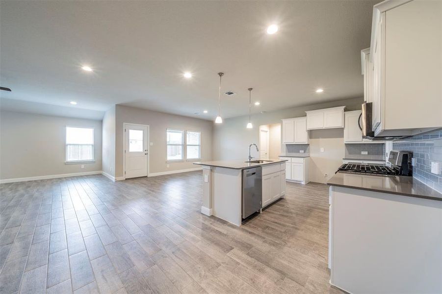 Door to backyard.  Wood look tile in all living space.  Carpet in bedrooms only.