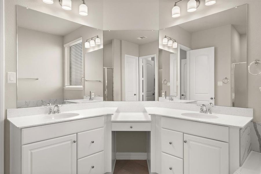 The en-suite bathroom offers a spa-like atmosphere with its elegant design, high end finishes, and tasteful lighting, creating a retreat within your own home.