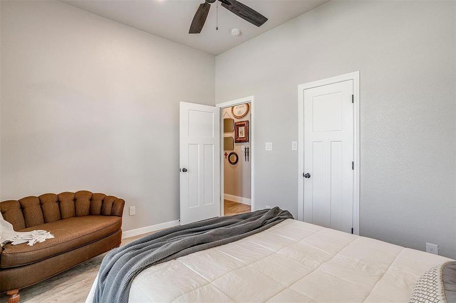Bedroom with ceiling fan and hardwood / wood-style floors