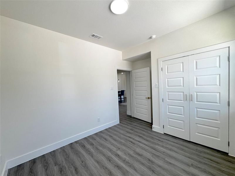 Unfurnished bedroom featuring wood-type flooring and a closet