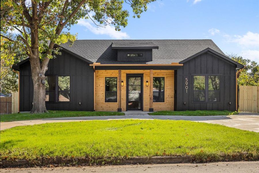 Modern farmhouse style home with a front yard