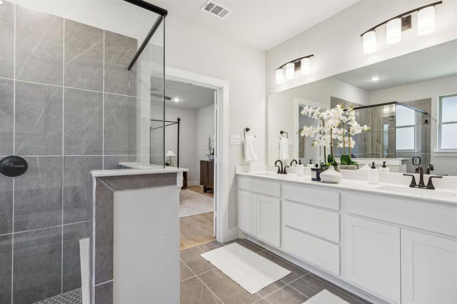 Bathroom featuring hardwood / wood-style flooring, a shower with door, and vanity