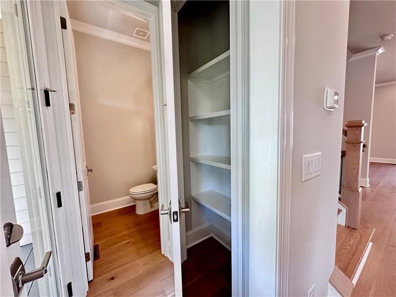 Enjoy additional pantry space off the kitchen with powder room, and rear deck access