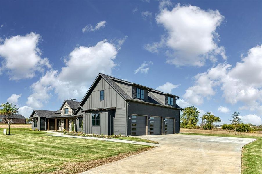 View of front of property with a front lawn and a garage