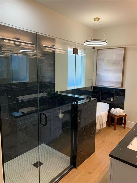 Bathroom with vanity, , separate shower and tub, and backsplash