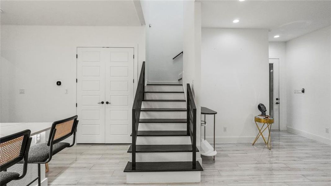 Stairway with light hardwood / wood-style flooring