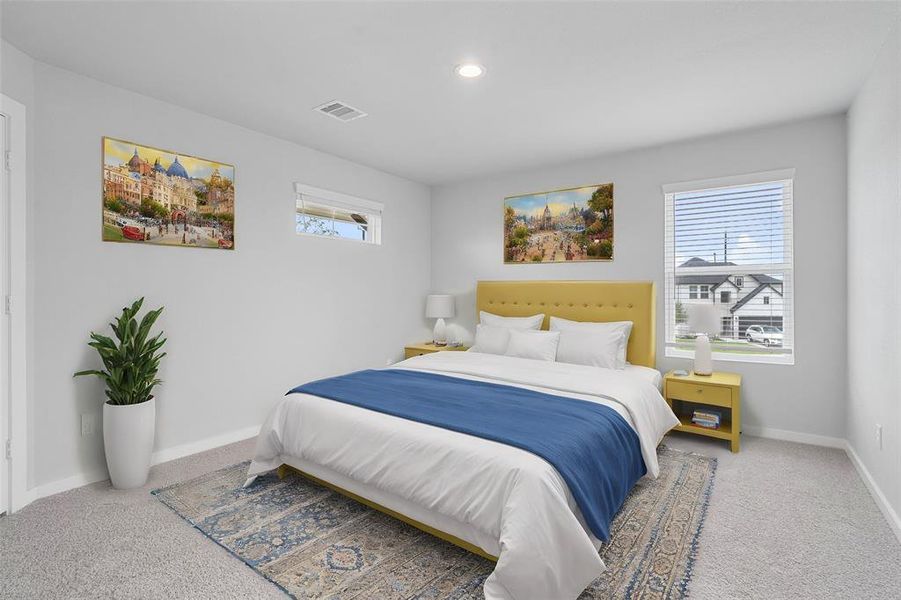 Secondary bedroom features plush carpet, custom paint, lighting, and large window with privacy blinds.