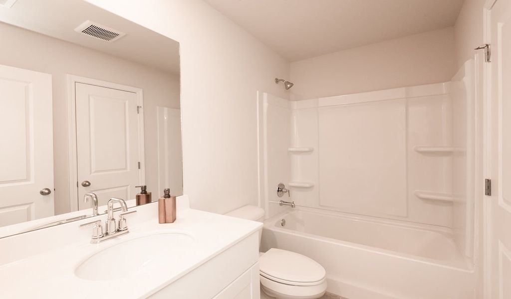 An upstairs secondary bathroom separates the secondary bedrooms.