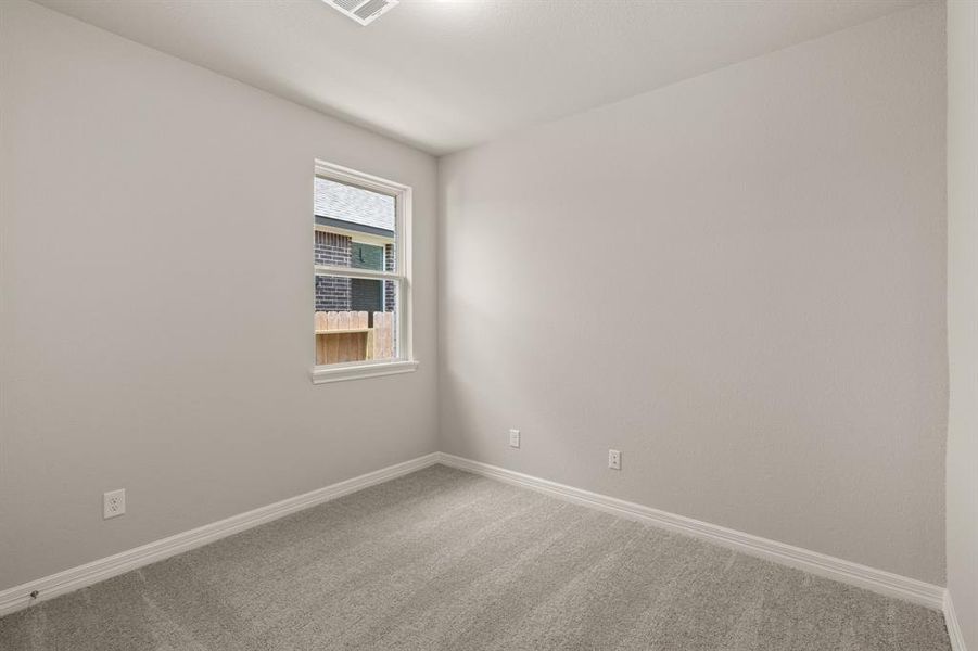 Your secondary bedroom features plush carpet, fresh paint, closet, and a large window that lets in plenty of natural lighting.