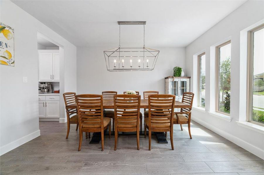 This bright, spacious dining area features large windows with an abundance of natural light, perfect for family dinners.