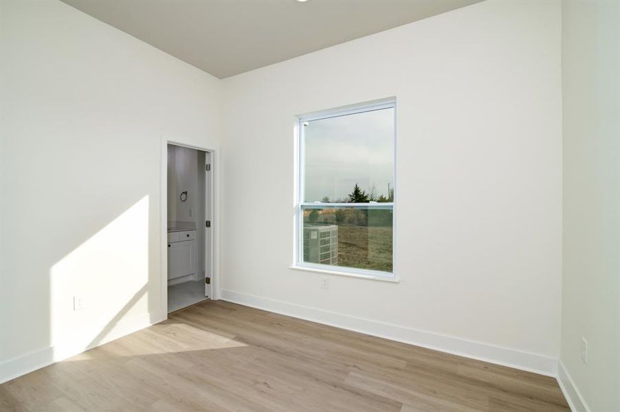 Empty room with light hardwood / wood-style floors