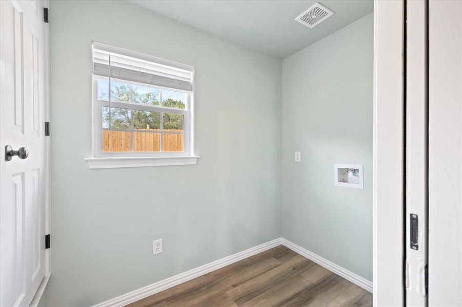 Laundry room with washer hookup and dark hardwood / wood-style flooring