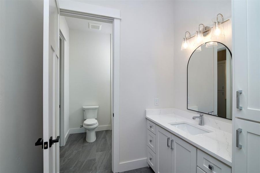 Bathroom featuring vanity and toilet