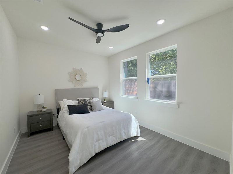 Bedroom featuring dark hardwood / wood-style flooring and ceiling fan