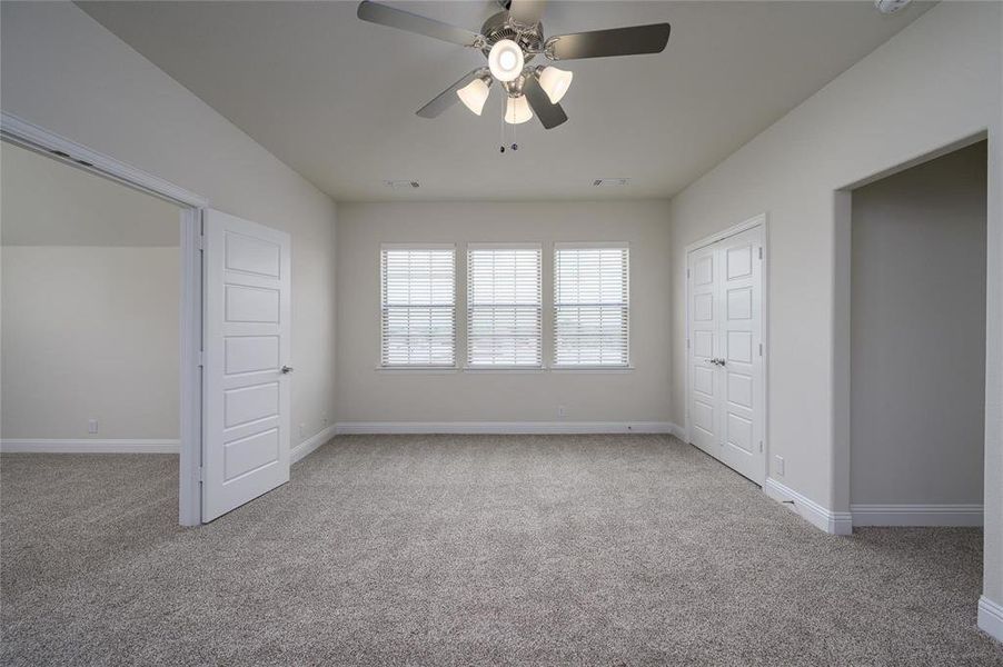 Unfurnished bedroom with a closet, carpet floors, and ceiling fan