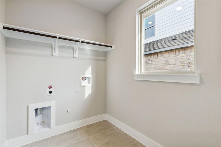 Laundry room featuring light tile flooring, electric dryer hookup, and washer hookup