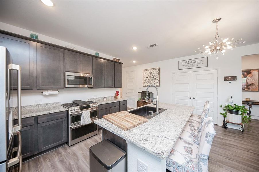 Alternate look at the kitchen.  The faucet at the kitchen sink is also new & elegant.  The double doors ahead are to the spacious pantry!