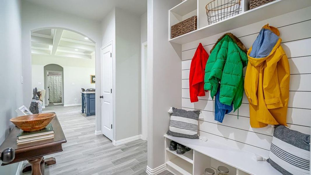 Mudroom with coffered ceiling, beamed ceiling, and light hardwood / wood-style floors