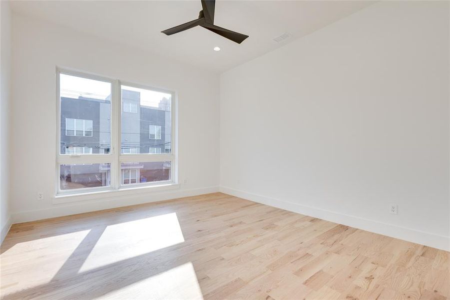 Unfurnished room featuring light hardwood / wood-style flooring and ceiling fan