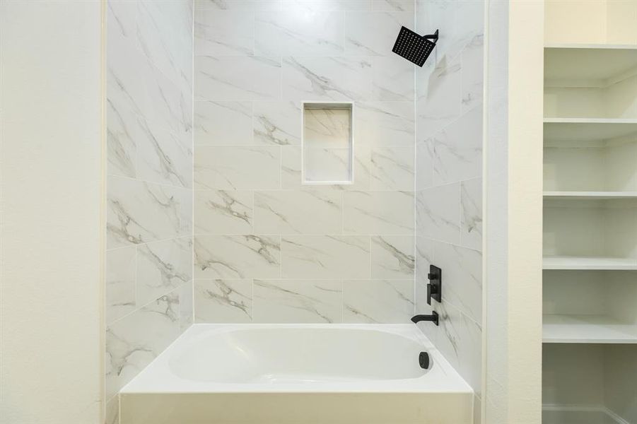 Tub/Shower combo surrounded by Quartz