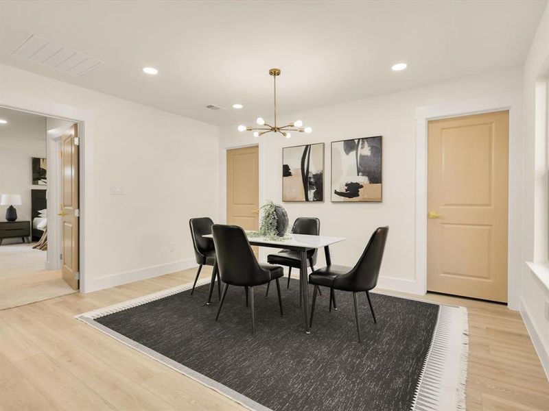 Dining space with wood-type flooring and a chandelier