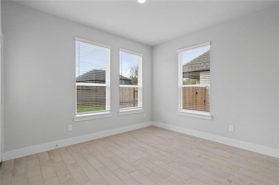 Start your day off right with a cup of coffee sitting with your family in the lovely breakfast area! Featuring large windows with blinds, custom neutral paint, tile flooring, recessed lighting and high ceilings!