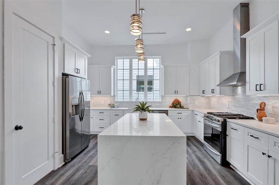 A full view of the kitchen showcases its stainless steel appliances. You'll love the gas range and the large waterfall island.