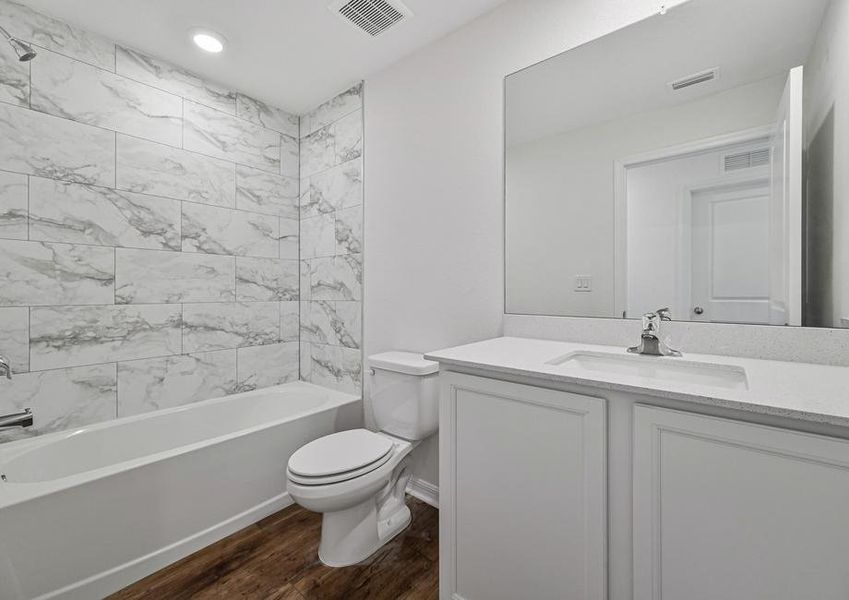 The extra bathroom has a spacious vanity with a tub