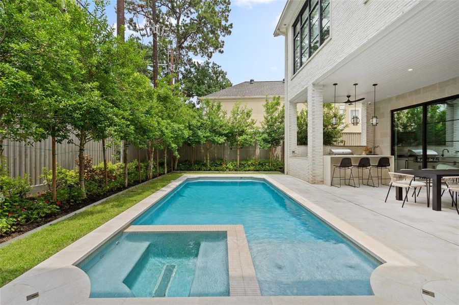 This incredible, sparkling, heated pool and spa features a stylish plastered base and stone surround, and a discreet low-profile commercial drain for safety.