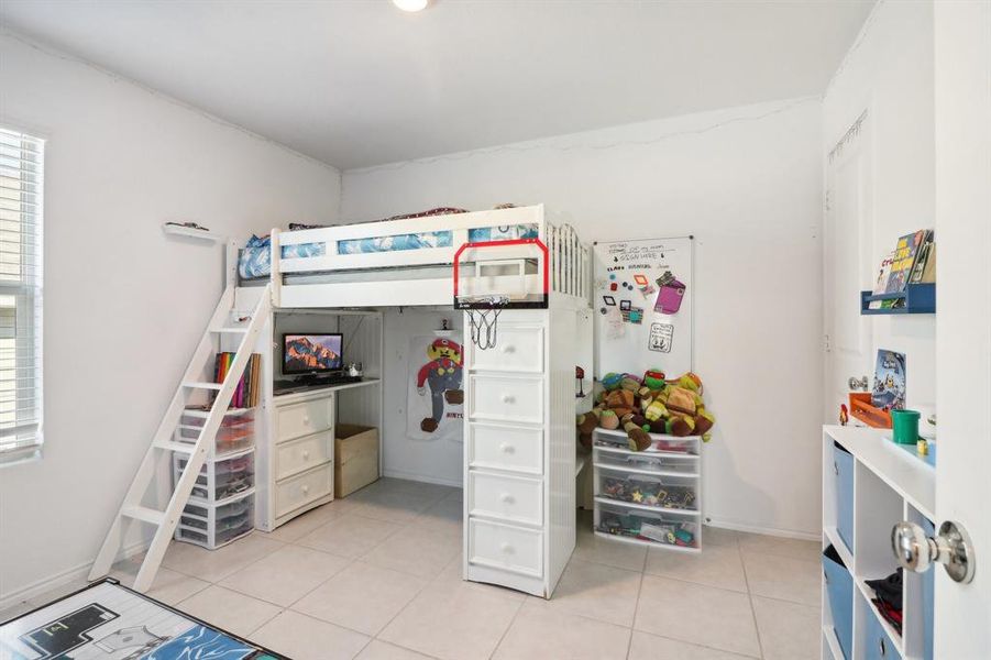 Bedroom with light tile patterned floors