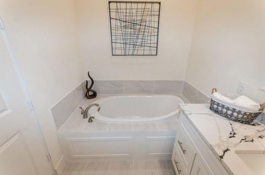 Bathroom with tiled bath and vanity