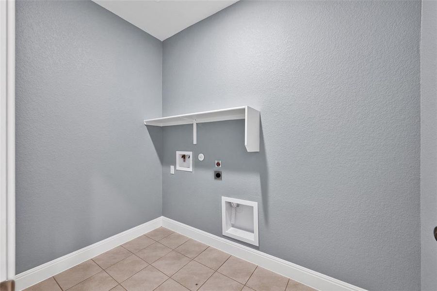 Laundry room is conveniently located off of the kitchen, across from the mudroom area.